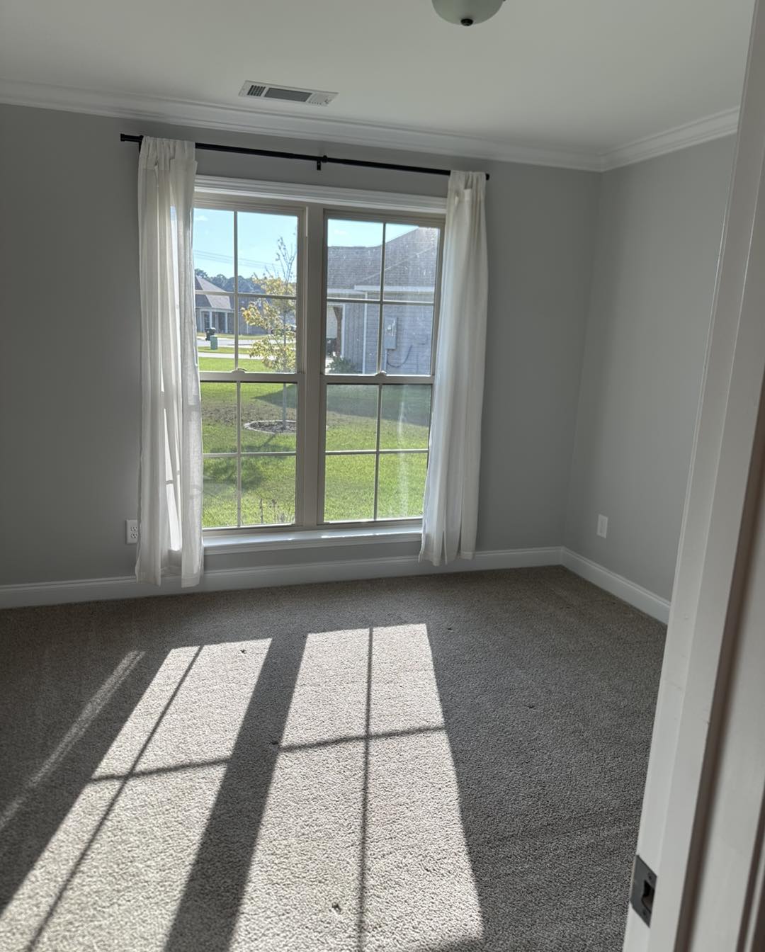 Clean room with bright windows and fresh carpet